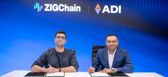 Two men sit at a signing ceremony table with the logos "ZIGChain" and "ADI" displayed on a blue backdrop above them, suggesting a partnership or collaboration announcement related to real-world asset (RWA) tokenization discussed in the post.