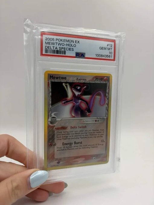 A PSA-graded 2005 Pokemon EX Delta Species Mewtwo card #12, graded GEM MT 10, held by a hand with light blue nail polish.