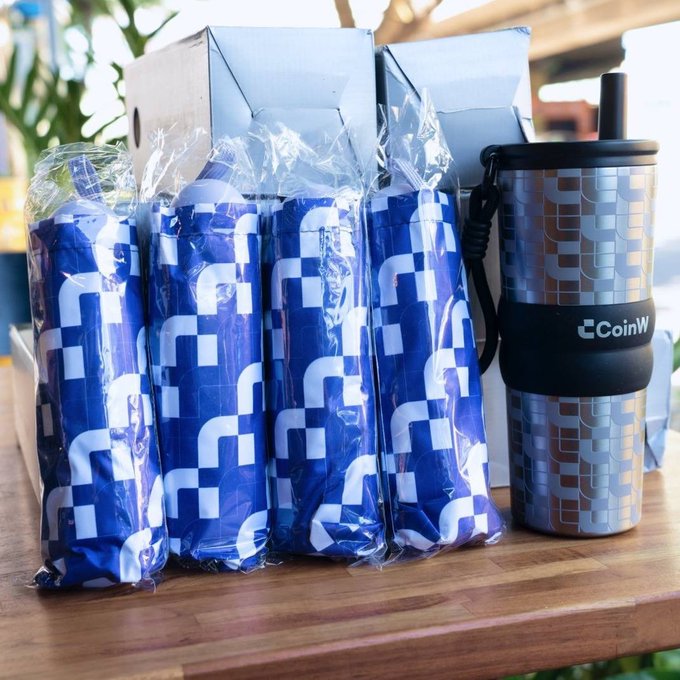 A promotional photo displays four blue patterned items wrapped in plastic alongside a metallic tumbler branded with the 'CoinW' logo.