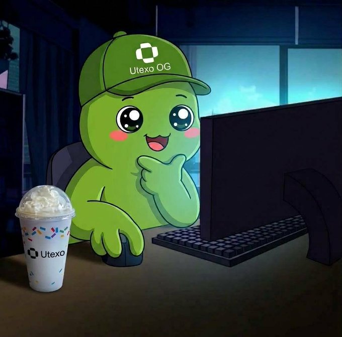 A cartoon mascot character for 'Utexo OG' sits at a computer with a happy expression, accompanied by a branded cup of a whipped cream-topped beverage on the desk.