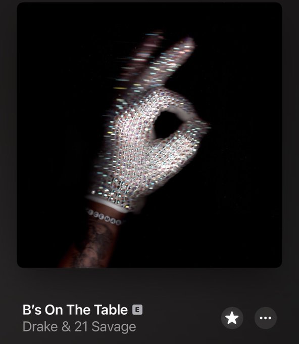 A gloved, rhinestone-covered hand forms an "OK" sign against a black background, with the song "B's On The Table" by Drake & 21 Savage displayed as the track title below.