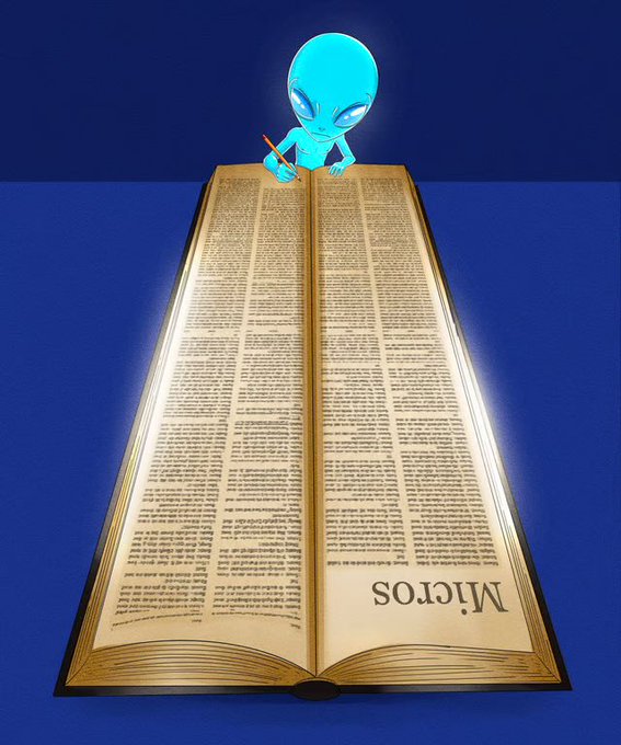 A blue cartoon alien sitting on a desk and writing in a large open book with the word 'MICROS' printed on the bottom of the pages.