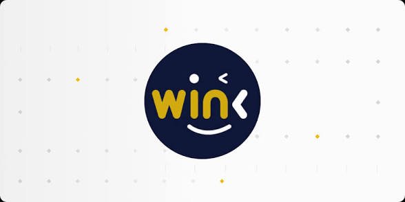 The image features a winking smiley face logo with "win<" text in yellow and white on a dark blue circular background, surrounded by a subtle dotted pattern. This WIN logo relates to the Binance Wallet campaign promoting low-fee WIN token transfers during the promotional period from September 23 to December 22, 2026.