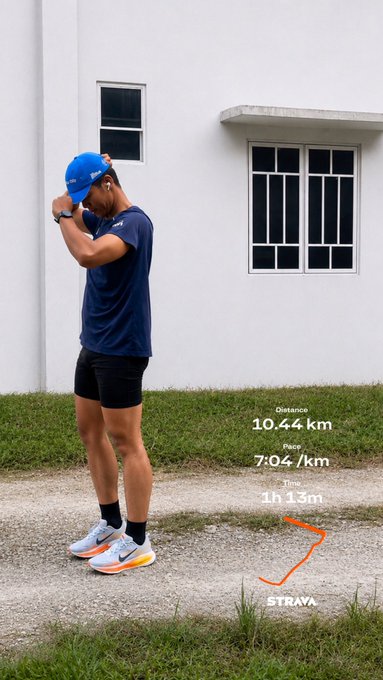 A Strava running summary showing a distance of 10.44 km, pace of 7:04/km, and time of 1h 13m, overlaid on a photo of a runner in blue attire standing outside a white building.