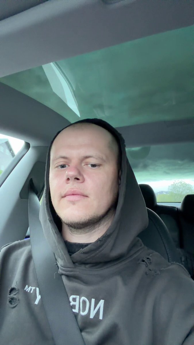 The image shows a man wearing a hooded sweatshirt, sitting inside a car with his head down. The hood of the car has a logo that reads "No. 1", indicating that he might be associated with or interested in space exploration. The photo also includes text that says "$spcx @SpaceX i hope you will deliver as im expecting". This suggests that the man is likely excited about the upcoming delivery and wants to ensure it arrives on time.