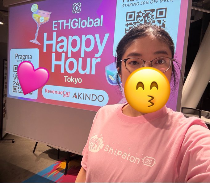 A selfie at an ETHGlobal Happy Hour Tokyo event, with visible sponsor logos including 'Pragma', 'RevenueCat', and 'AKINDO', and the attendee's face obscured by a kissing emoji.