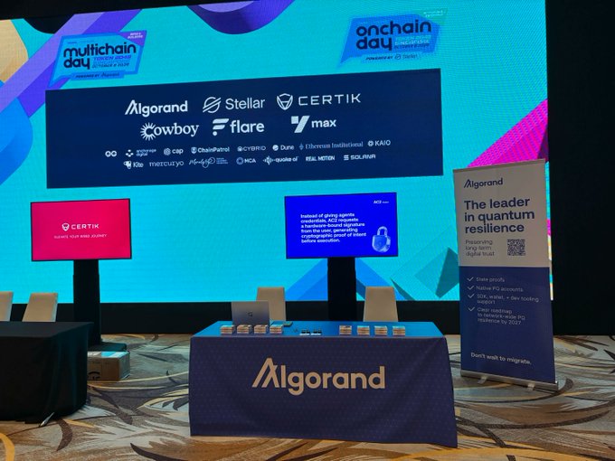 Algorand's branded booth at TOKEN2049 Singapore's Multichain Day displays a large screen featuring event sponsors (Stellar, Flare, Owlboy, Certik, and more) alongside messaging about "The leader in quantum resilience," highlighting features like post-quantum cryptography and state proofs, aligning with the team's efforts to educate enterprises about Q-Day preparation.