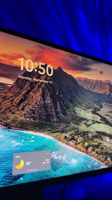 A smart display screen showing a lock screen with a tropical mountain landscape, displaying the time "10:50" and date "Monday, September 14," along with a weather widget for Lagos showing 79° and "Clear."