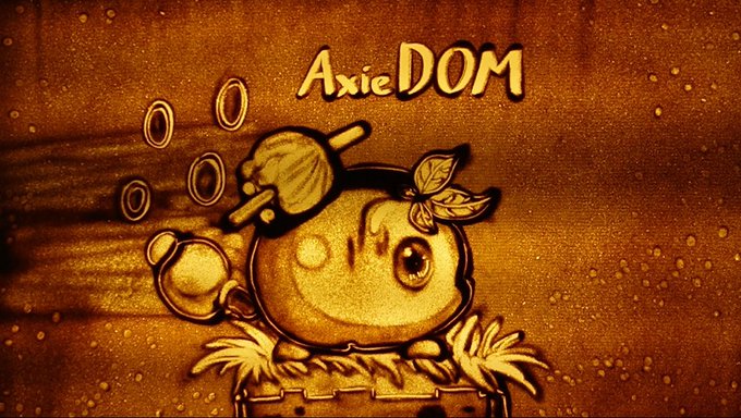 A sand art drawing of an Axie character with the text 'Axie DOM' at the top.