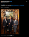 A small screenshot of an X/Twitter post showing two people in suits in what appears to be a barbershop or salon setting, with text referencing high light bills and barbershops.