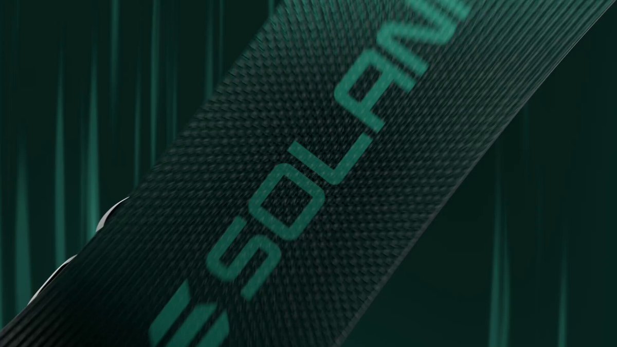 The image features a close-up of a green strap, possibly made from carbon fiber or another material, with the word "solana" written across it. The background appears to be a dark color, which contrasts with the bright green of the strap. There is no text present in the image, and the focus seems to be on the strap itself rather than any accompanying text.
