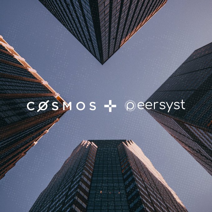 A low-angle shot looking up at four skyscrapers converging toward a blue sky, overlaid with the text "cosmos + peersyst" — visually reinforcing the post's message that COSMOS is far from dead, instead standing tall and prominent alongside its partner Peersyst.