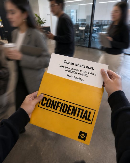 A first-person view of hands holding a yellow 'CONFIDENTIAL' envelope in an office setting; a card peeking out reads 'Guess what's next. Take your chance to win a share of $3,000 in USDC. Hint 1 loading...'.