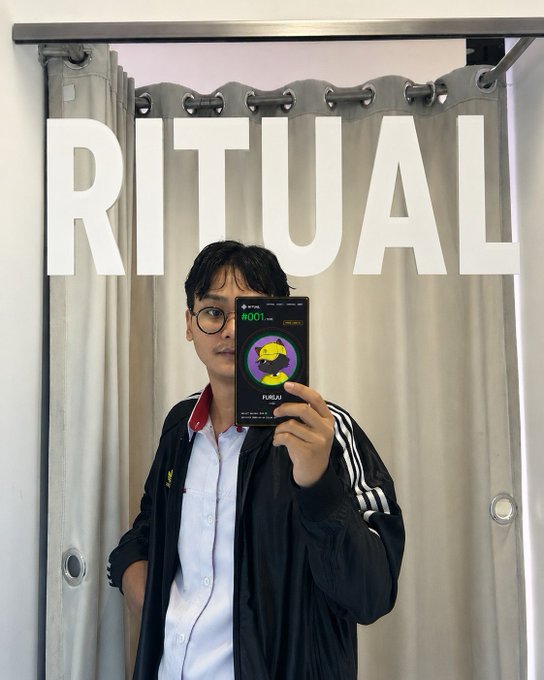 A man takes a mirror selfie in front of a curtain with "RITUAL" displayed prominently behind him, while holding a phone showing the "Ritual" app interface — fitting the post's reflection on surviving a long, exhausting work week at @ritualnet.