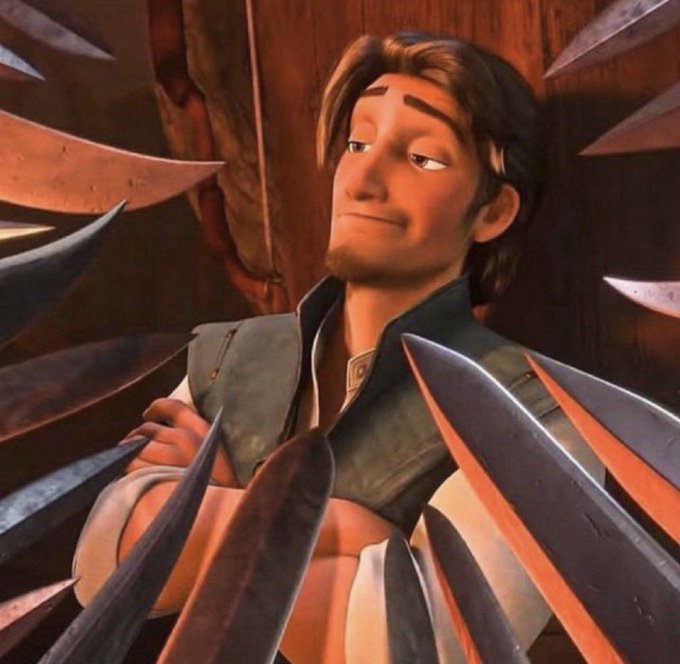 An animated character with dark hair and a vest stands with arms crossed, surrounded by sharp pointed objects in a scene from the film Puss in Boots.