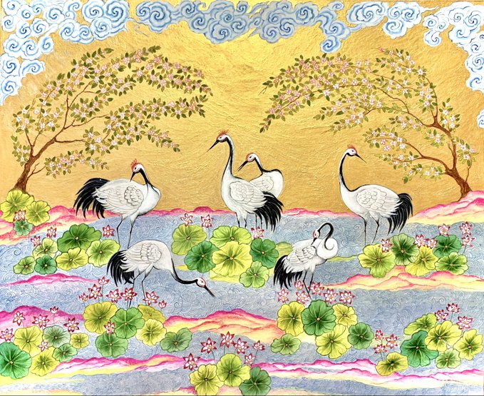 A vibrant Thai-style painting depicting several cranes in a landscape with green lotus flowers, flowing water, and pink blossoming trees against a gold background.