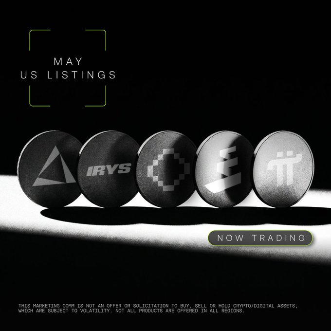The image features five coins, each with a different symbol or logo on them. The coins are arranged in a row against a black background. Below the coins, there's text that reads "5 for May Check out our hot US listings for the month of May and stay tuned for more." This suggests that the coins might be related to cryptocurrency trading or investing, as they appear to be part of a collection or display meant to showcase different types of digital assets.