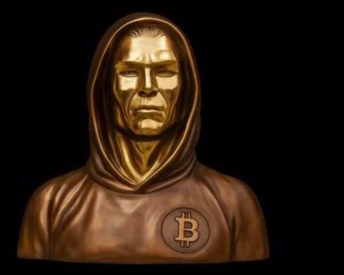 A bronze statue of a hooded figure with a Bitcoin (₿) emblem on its chest, symbolizing the revered "whales" or legendary crypto investors predicting a major BTC bull run, visually reinforcing the post's message about a forecasted super cycle and massive price surge for Bitcoin.