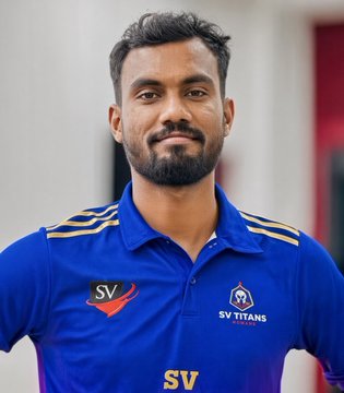 A portrait of a smiling man with dark hair and a beard wearing a blue SV Titans sports jersey.