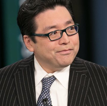 A man wearing glasses, a dark pinstripe suit, white shirt, and patterned tie appears to be in a television interview setting, likely a financial news program. The image accompanies breaking news about Bitmine acquiring an additional 28,086 ETH, bringing the company closer to holding 5% of Ethereum's total supply.