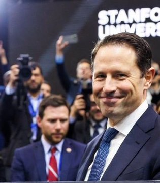 A smiling man in a dark suit and blue tie poses for photos in front of a Stanford University banner, with photographers visible in the background. The image appears to be used to lend credibility to the post's claim that Stanford scientists and technologists will lead a "global digital monetary revolution," implying a connection to PI Network.