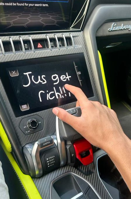 A person's finger is shown writing 'Jus get rich!!' on the touchscreen of a Lamborghini's center console.