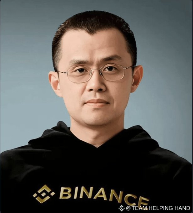 A portrait of a man wearing glasses and a black Binance hoodie, with '@TEAM.HELPING HAND' watermarked in the corner.