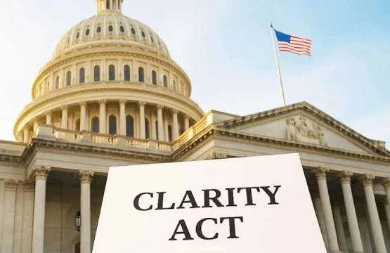 The US Capitol building is shown with an American flag flying and a white sign reading 'CLARITY ACT' in the foreground.