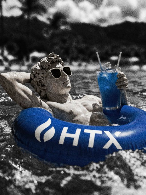 A classical-style statue wearing sunglasses floats in an HTX-branded pool ring, holding a blue tropical drink with a straw against a black-and-white tropical backdrop.