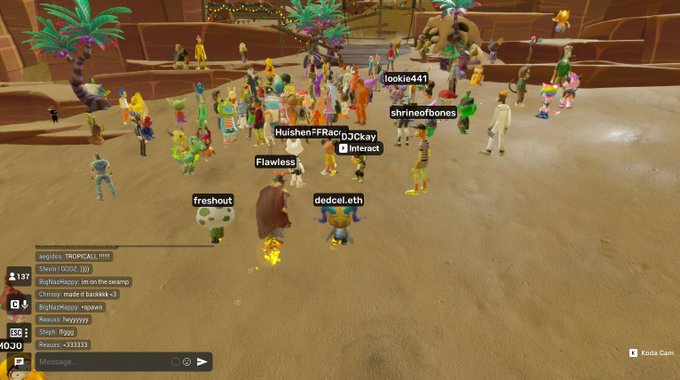 A screenshot from a Roblox game showing numerous player avatars gathered in a sandy area with usernames like 'Flawless', 'freshout', 'dedlol.eth', and 'HuishenFFRaccDJCsKy' visible.