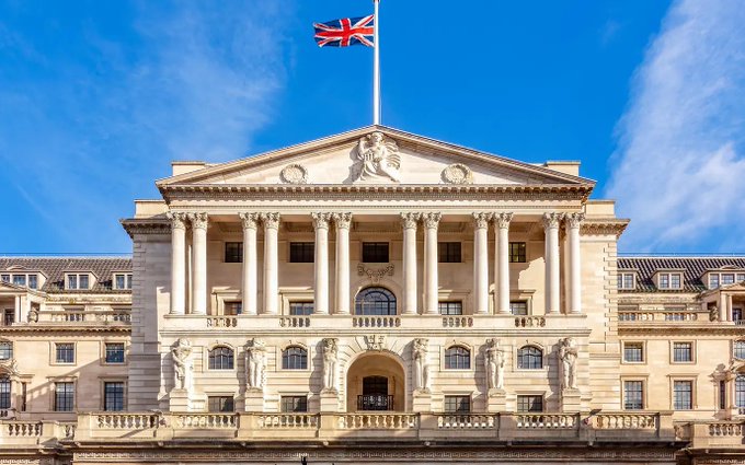 The image features a large, ornate building that appears to be an old government building or a historical landmark. The building has a British flag flying atop of it, indicating its connection to the United Kingdom. In the background, there are some buildings visible as well. The main focus of the image is on the building itself and not on any other elements in the scene.