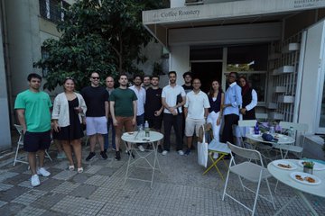 A group of approximately 15 people pose together at an outdoor gathering at Hi Coffee Roastery, where coffee cups and pastries are visible on nearby tables, reflecting the Stellar Turkey Meet-Up event described in the post.