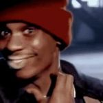 A man in a red beanie smiles and points to his chin, as if posing a thoughtful or skeptical question. The image pairs humorously with the post speculating whether an 80 million Ledger drain could be used to bid on $ZEC.