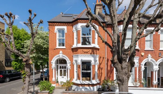 A grand red-brick Victorian end-of-terrace house with white-trimmed bay windows stands on a leafy London street, the dream property that crypto success helped its proud owner acquire.