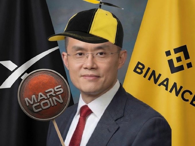 A man in a suit and red tie wears a yellow and black propeller hat and holds a sign reading 'MARS COIN', with Binance and what appears to be an XRP flag in the background.