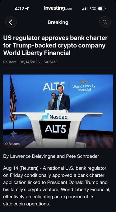 A screenshot from Investing.com shows a Reuters article dated 08/14/2026 with the headline "US regulator approves bank charter for Trump-backed crypto company World Liberty Financial," featuring a photo of two men at a Nasdaq podium for ALT5. The news of regulatory approval for the Trump-backed stablecoin venture World Liberty Financial ($WLFI) directly relates to the post's claim of $WLFI skyrocketing, as bank charter approval represents a major catalyst for the token's price surge.