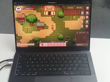 An open laptop on a desk displays a pixel-art farming simulation game running in a web browser.