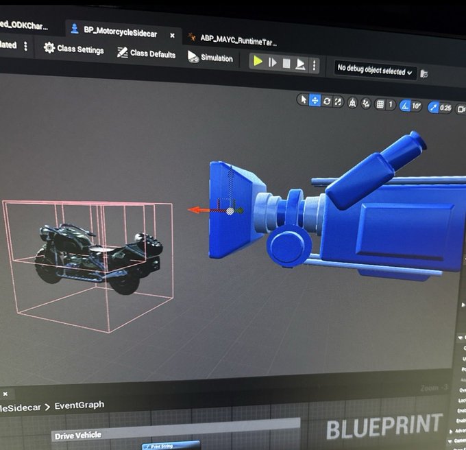 A computer monitor displaying Unreal Engine's Blueprint interface with a 3D model of a motorcycle sidecar and a blue mechanical component.