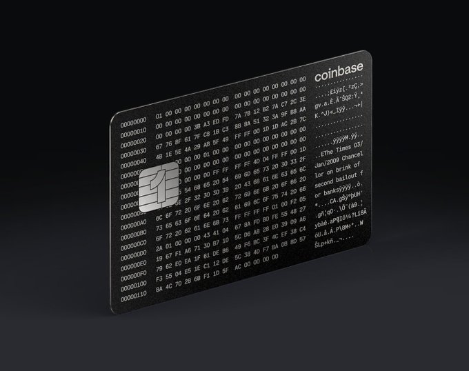 A black Coinbase cryptocurrency card displayed against a dark background, featuring the Coinbase logo and lines of code/hexadecimal text printed on its surface.