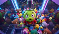 A green apple character in a superhero costume stands amid a crowd of plush toys under neon lights.