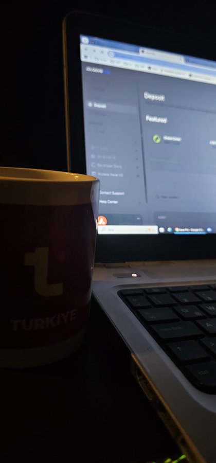 A laptop screen showing the dosivo deposit page with Bassive token featured, alongside a red and white cup labeled 'TÜRKIYE' on the desk.