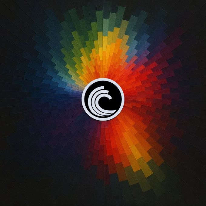 A circular logo featuring a stylized 'C' design surrounded by a pixelated, rainbow-colored radial burst pattern.