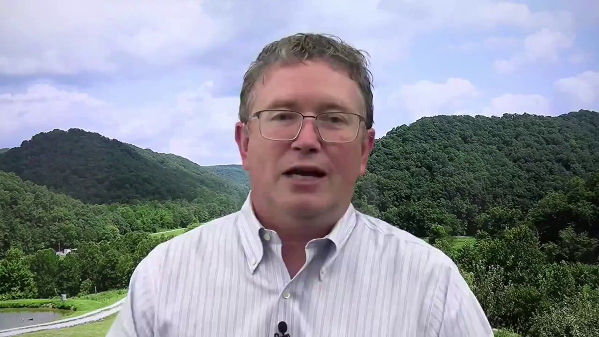 The image features a man wearing glasses, standing against a backdrop of mountains and trees. He appears to be giving a speech or presentation, as indicated by the text "Rep. Thomas Massie says reading The Bitcoin Standard inspired his bill to end the Fed." This suggests that the man might be discussing the impact of Bitcoin on the financial system or advocating for changes in existing policies.

The mountains and trees in the background provide a natural setting for the scene, which further emphasizes the importance of the topic being discussed by the man. The image captures both the speaker's face and his surroundings, creating an engaging visual experience that complements the text.