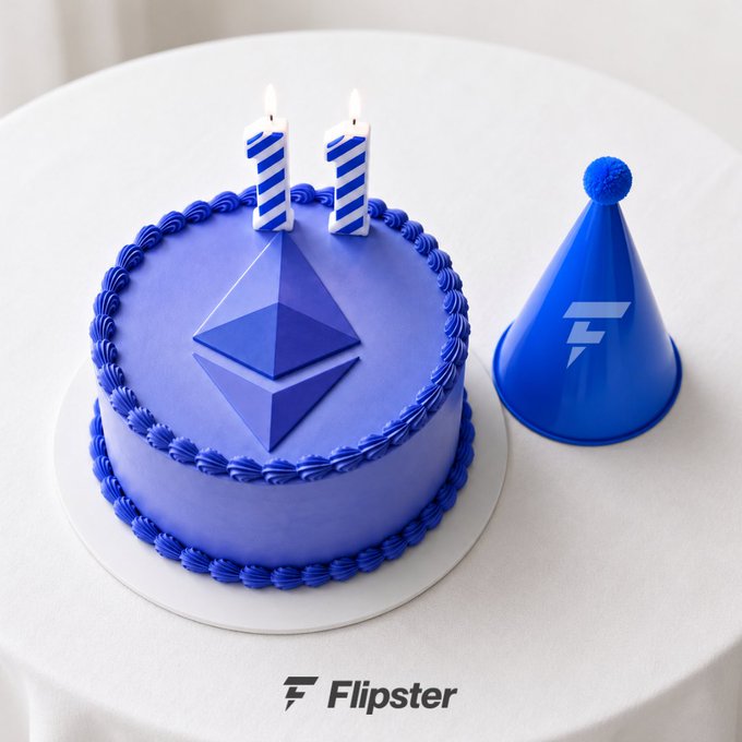 A blue and purple birthday cake decorated with the Ethereum logo and two candles shaped like the number '11', sitting next to a blue party hat with the Flipster 'F' logo on a white table.