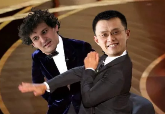 The image features two men dressed in suits, with one man wearing a blue suit and the other wearing a black suit. They are both smiling at the camera while dancing together. The background of the image shows an oval-shaped stage or platform where they are performing on.