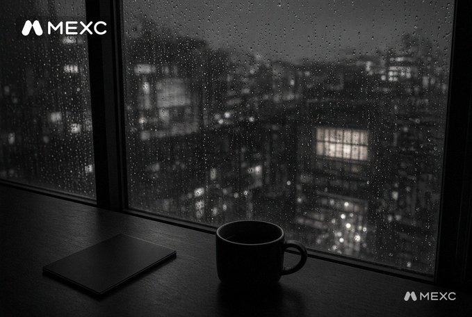 A moody, black-and-white scene of a coffee mug and a closed laptop on a windowsill overlooking a rainy cityscape, with 'MEXC' watermarks.