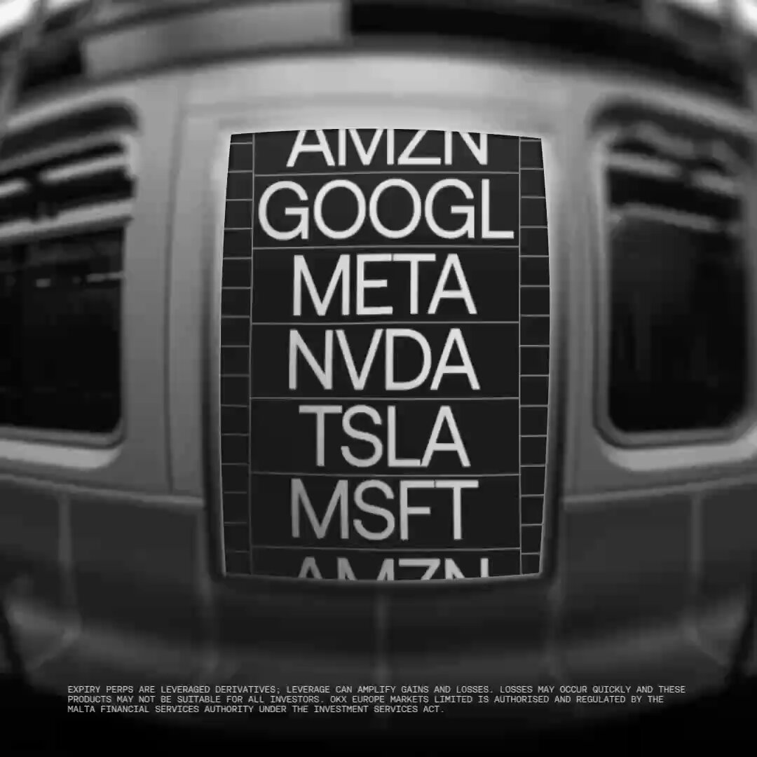 The image shows a subway car with a large sign that says "AMAZN" above it, which indicates that the train is operated by Amazon. The sign also includes other text related to Google and Meta, suggesting that this train may be part of a transportation network or service provided by these companies. The sign reads: "AMAZN", "Google", "Meta", "NVDA", "TSLA MSSFT", and "AMAZN".