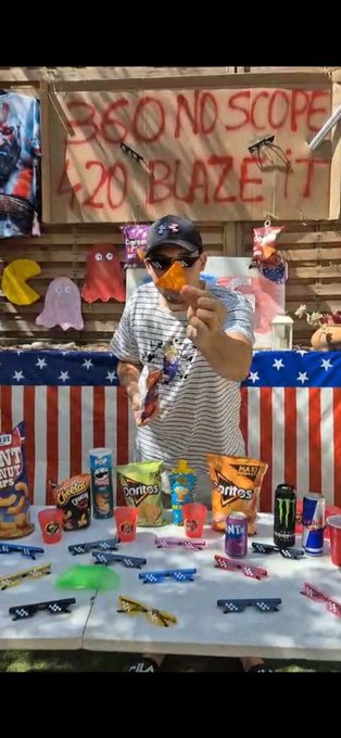 A man in a USA-themed shirt and sunglasses holds a Dorito chip at a party booth with banners reading "360 NO SCOPE" and "4.20 BLAZE IT," surrounded by Doritos, Doritos, and $MLG merchandise like cups and sunglasses in celebration of his birthday and a $MLG-themed gathering.