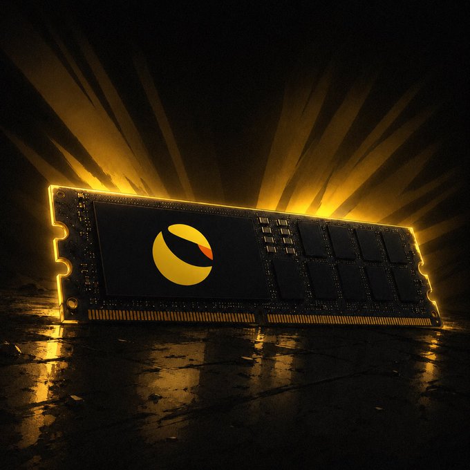 A RAM stick stands upright on a dark, cracked surface, illuminated by dramatic golden rays bursting from behind it. The central chip features a glowing yellow and orange logo, visually representing the technical foundation and restoration theme of Terra Classic ($LUNC).
