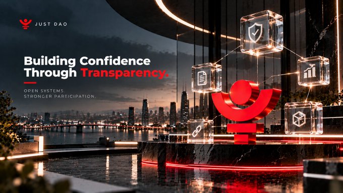 A promotional banner for "JUST DAO" reading "Building Confidence Through Transparency" with "OPEN SYSTEMS, STRONGER PARTICIPATION," featuring a red logo and floating glass icons over a city skyline at night.